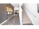Inviting entryway featuring hardwood floors, a staircase, and a view into the dining and living areas at 12106 Conrad Cir, Hampton, GA 30228