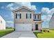 Charming two-story home with a two-car garage and well-manicured lawn in a suburban neighborhood at 12106 Conrad Cir, Hampton, GA 30228