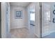 Bright hallway with neutral carpet, white trim and doorways showcasing the home's open layout at 12106 Conrad Cir, Hampton, GA 30228