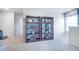 Carpeted hallway with dark wood bookshelves and a window with natural light at 12106 Conrad Cir, Hampton, GA 30228