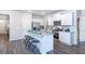 Bright open kitchen featuring a large island, stainless steel appliances, and granite countertops at 12106 Conrad Cir, Hampton, GA 30228