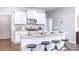 Modern kitchen featuring white cabinets, granite countertops, and stainless steel appliances at 12106 Conrad Cir, Hampton, GA 30228
