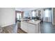 Spacious kitchen island featuring a granite countertop, stainless steel dishwasher, and an open floor plan at 12106 Conrad Cir, Hampton, GA 30228