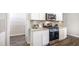 Modern kitchen with stainless steel appliances, white cabinetry, gray subway tile backsplash, and a granite countertop at 12106 Conrad Cir, Hampton, GA 30228
