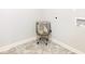 Neutral laundry room with decorative tile flooring and a round wire laundry basket at 12106 Conrad Cir, Hampton, GA 30228