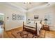Bedroom with tray ceiling and hardwood floors, accented by a detailed rug and shuttered windows at 4224 Gateland Ave, Marietta, GA 30062