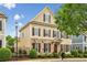 Attractive home exterior with stone accents, yellow siding, brown shutters, and lush landscaping at 4224 Gateland Ave, Marietta, GA 30062