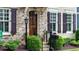 Close-up of the front door, showcasing stone accents, dark shutters, and a well-manicured yard at 4224 Gateland Ave, Marietta, GA 30062