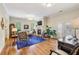 Spacious living room featuring hardwood floors, a fireplace, comfortable seating, and a work area at 4224 Gateland Ave, Marietta, GA 30062