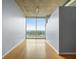Bright hallway with hardwood flooring and a large window overlooking a lush landscape at 923 Peachtree Ne St # 1334, Atlanta, GA 30309