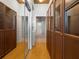Hallway with natural wood floors, washer/dryer, and glass-door cabinets for ample storage at 923 Peachtree Ne St # 1334, Atlanta, GA 30309