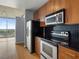 Modern kitchen with stainless steel appliances, granite countertops, and tile backsplash at 923 Peachtree Ne St # 1334, Atlanta, GA 30309