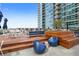 Outdoor patio with wood deck, modern seating, tables, and building views at 923 Peachtree Ne St # 1334, Atlanta, GA 30309