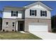 Charming two-story home featuring brick and siding exterior, a two-car garage, and well-manicured lawn at 2399 Argento Cir, Dacula, GA 30019