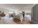 Open-concept kitchen with granite countertops, stainless steel appliances, white cabinets, and an island with seating at 2399 Argento Cir, Dacula, GA 30019