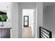 Bright hallway with a view of a bathroom and entryway with wooden floors at 3336 Myrtle St, Atlanta, GA 30354
