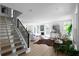 Bright living room featuring a staircase, large windows, and stylish decor at 3336 Myrtle St, Atlanta, GA 30354