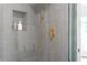 Close-up of the gray-tiled shower with gold fixtures and built-in shelving at 3336 Myrtle St, Atlanta, GA 30354