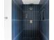 Modern tiled shower with vertical tiles and brass fixtures at 3336 Myrtle St, Atlanta, GA 30354
