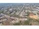 An aerial view of a densely populated neighborhood surrounded by mature trees and roads at 4803 Austin Hills Dr, Suwanee, GA 30024
