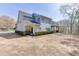 Wide backyard with partial fencing, mature trees and partial rear view of home at 4803 Austin Hills Dr, Suwanee, GA 30024
