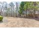 Spacious backyard featuring a play set, mature trees, and partial fencing at 4803 Austin Hills Dr, Suwanee, GA 30024