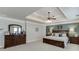 Main bedroom with a tray ceiling, fan, and nice furniture at 4803 Austin Hills Dr, Suwanee, GA 30024