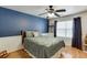 Blue bedroom with wood floors, wainscotting and a large window at 4803 Austin Hills Dr, Suwanee, GA 30024