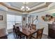 Elegant dining area with crown molding, large window and hardwood floors with a view into the foyer at 4803 Austin Hills Dr, Suwanee, GA 30024