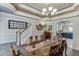 Charming dining room with a large wooden table and seating for six, leading to an open floorplan layout at 4803 Austin Hills Dr, Suwanee, GA 30024