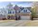 Beautiful two-story brick home featuring a covered porch, attached two car garage and meticulously maintained landscaping at 4803 Austin Hills Dr, Suwanee, GA 30024