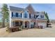 Attractive two-story home with brick and siding, offering a welcoming front porch and a spacious two-car garage at 4803 Austin Hills Dr, Suwanee, GA 30024