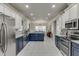 Spacious kitchen features stainless steel appliances, dual-tone cabinets, and granite countertops at 4803 Austin Hills Dr, Suwanee, GA 30024
