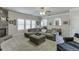 Open concept living room with fireplace, archways, grey furniture and natural light at 4803 Austin Hills Dr, Suwanee, GA 30024