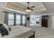 Spacious main bedroom with a trey ceiling, carpet, and ensuite bath with adjacent gym at 4803 Austin Hills Dr, Suwanee, GA 30024