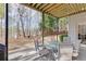 Patio in wooded backyard with seating and shade from elevated deck at 4803 Austin Hills Dr, Suwanee, GA 30024