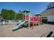 Well-maintained community playground equipment adjacent to a swimming pool at 4803 Austin Hills Dr, Suwanee, GA 30024