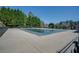 Outdoor pool is closed for the winter season, covered with a green tarp surrounded by a gray cement base and wrought iron fence at 4803 Austin Hills Dr, Suwanee, GA 30024