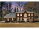 Charming two-story red brick home with a manicured front lawn and mature trees in a desirable neighborhood at 5110 Montcalm Sw Dr, Atlanta, GA 30331