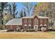 Charming two-story red brick home with a manicured front lawn and mature trees in a desirable neighborhood at 5110 Montcalm Sw Dr, Atlanta, GA 30331