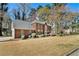 A view of the front yard of a brick home, showcasing its well-maintained lawn and mature landscaping at 5110 Montcalm Sw Dr, Atlanta, GA 30331