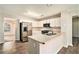 Modern kitchen with stainless steel appliances, white cabinets, and a view into the living area at 5110 Montcalm Sw Dr, Atlanta, GA 30331