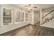 Bright living area with a fan, large windows, and a staircase at 5110 Montcalm Sw Dr, Atlanta, GA 30331