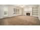 Cozy living room featuring a fireplace, built-in shelving, and a door to the backyard at 5110 Montcalm Sw Dr, Atlanta, GA 30331