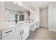 Bright bathroom featuring double sinks, quartz countertops, white cabinets and modern fixtures at 117 Villanueva Rd, Woodstock, GA 30188