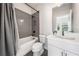 Modern bathroom with a gray tiled shower, white toilet, and white vanity at 117 Villanueva Rd, Woodstock, GA 30188