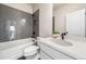 Modern bathroom with gray tiled shower, white vanity, and updated fixtures at 117 Villanueva Rd, Woodstock, GA 30188
