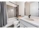 Modern bathroom with gray tiled shower, white vanity, and updated fixtures at 117 Villanueva Rd, Woodstock, GA 30188
