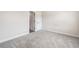 Neutral bedroom with light gray carpet and white trim around doors and baseboards at 117 Villanueva Rd, Woodstock, GA 30188