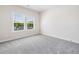 Bright, neutral bedroom with plush gray carpeting and ample natural light at 117 Villanueva Rd, Woodstock, GA 30188
